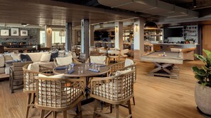 A spacious lounge area with a pool table, comfortable seating, and a bar area with a television. - Newport Harbor Island Resort (Newport)