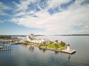 A waterfront hotel with a marina, a lighthouse, and a large building with multiple floors. - Newport Harbor Island Resort (Newport)