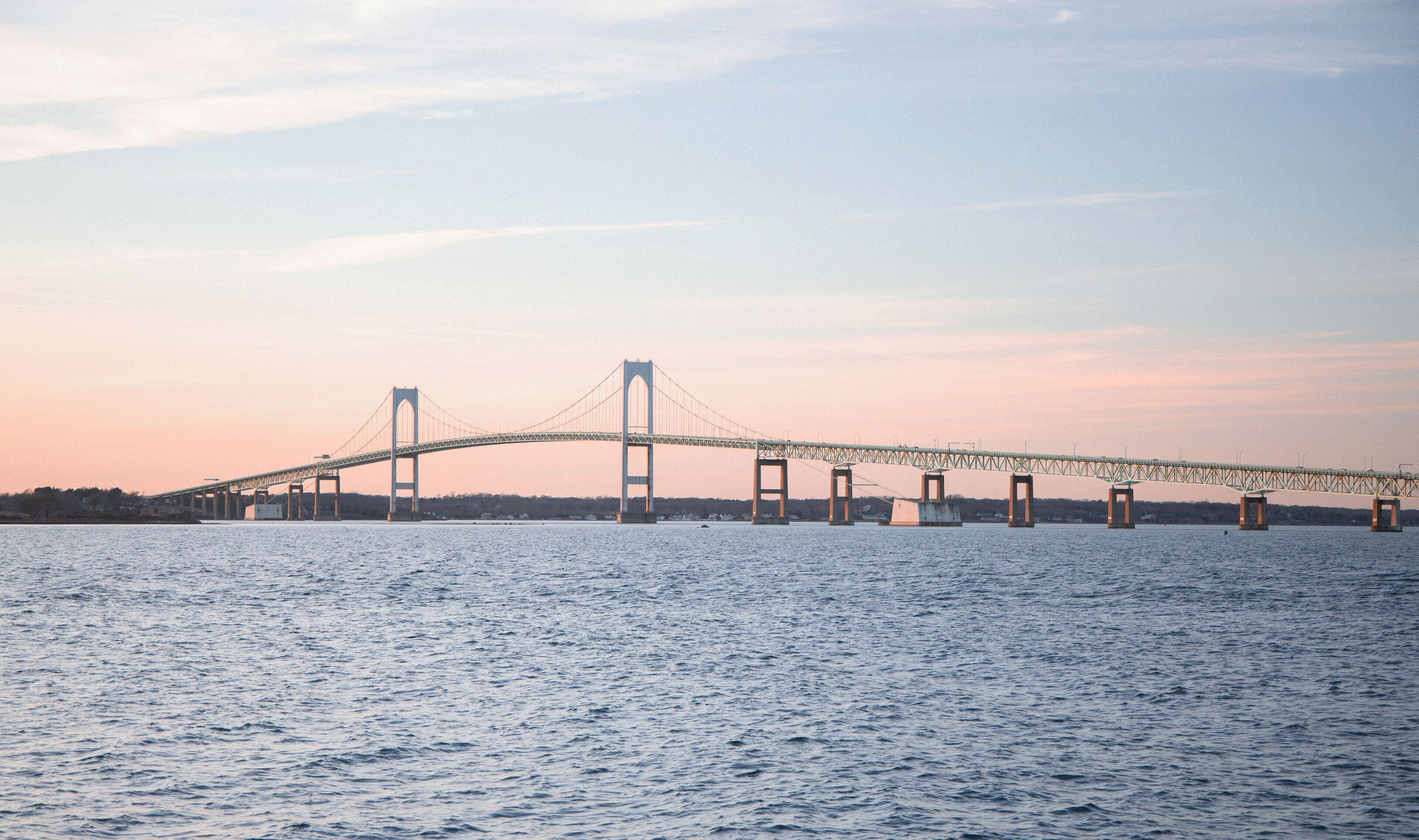A large suspension bridge spanning a wide river.