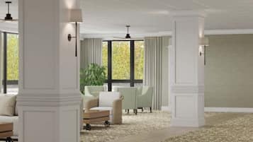 A spacious room with high ceilings, large windows, and a patterned carpet.