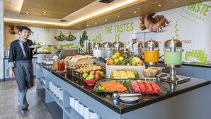 A buffet with a variety of food items and a wall with the text "The Tastes of Thailand". - ibis Bangkok IMPACT (Pak Kret)