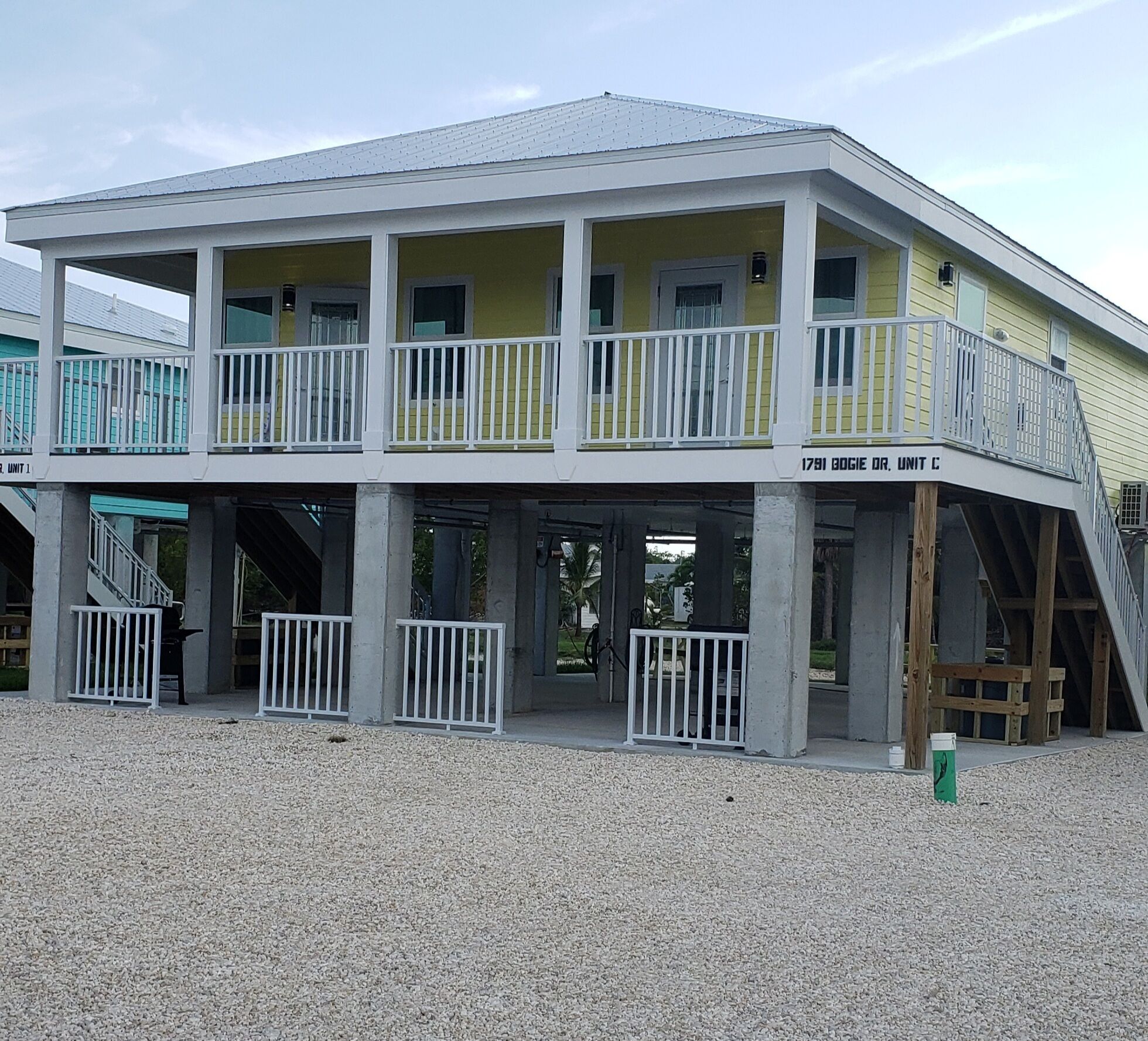 A two-story building with a balcony on the upper floor, labeled "1791 BOGIE DR. UNIT C".