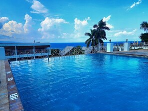 Outdoor pool, open 8 AM to 4 PM, pool umbrellas, pool loungers