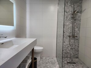 Shower, designer toiletries, towels