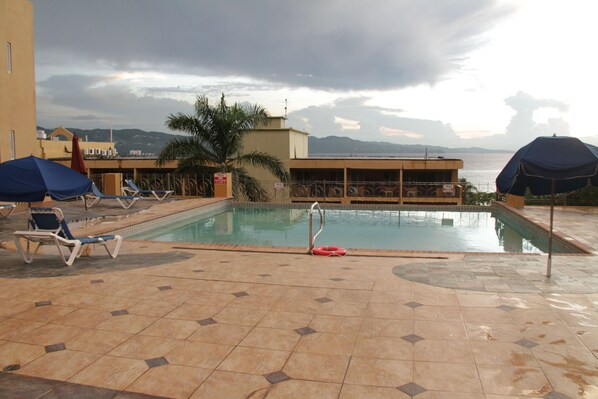 Outdoor pool, open 8 AM to 4 PM, pool umbrellas, pool loungers