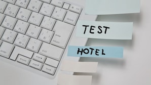 A keyboard with sticky notes labeled "TEST HOTEL". - EQC Hotel 771 (Birr)