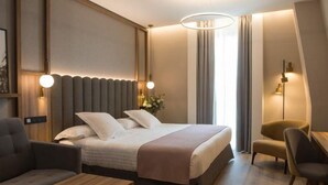 A modern hotel room with a large bed, a desk, a chair, and a sofa. - EQC Hotel 776 (Osaka)