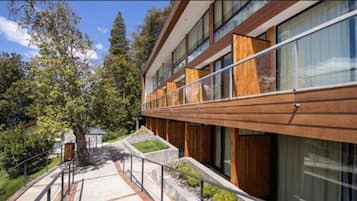 A modern building with large windows and wooden paneling.