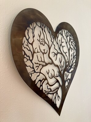A heart-shaped wall art with a tree-like pattern.