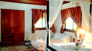 A bedroom with a four-poster bed, a wooden wardrobe, and a large window with curtains.