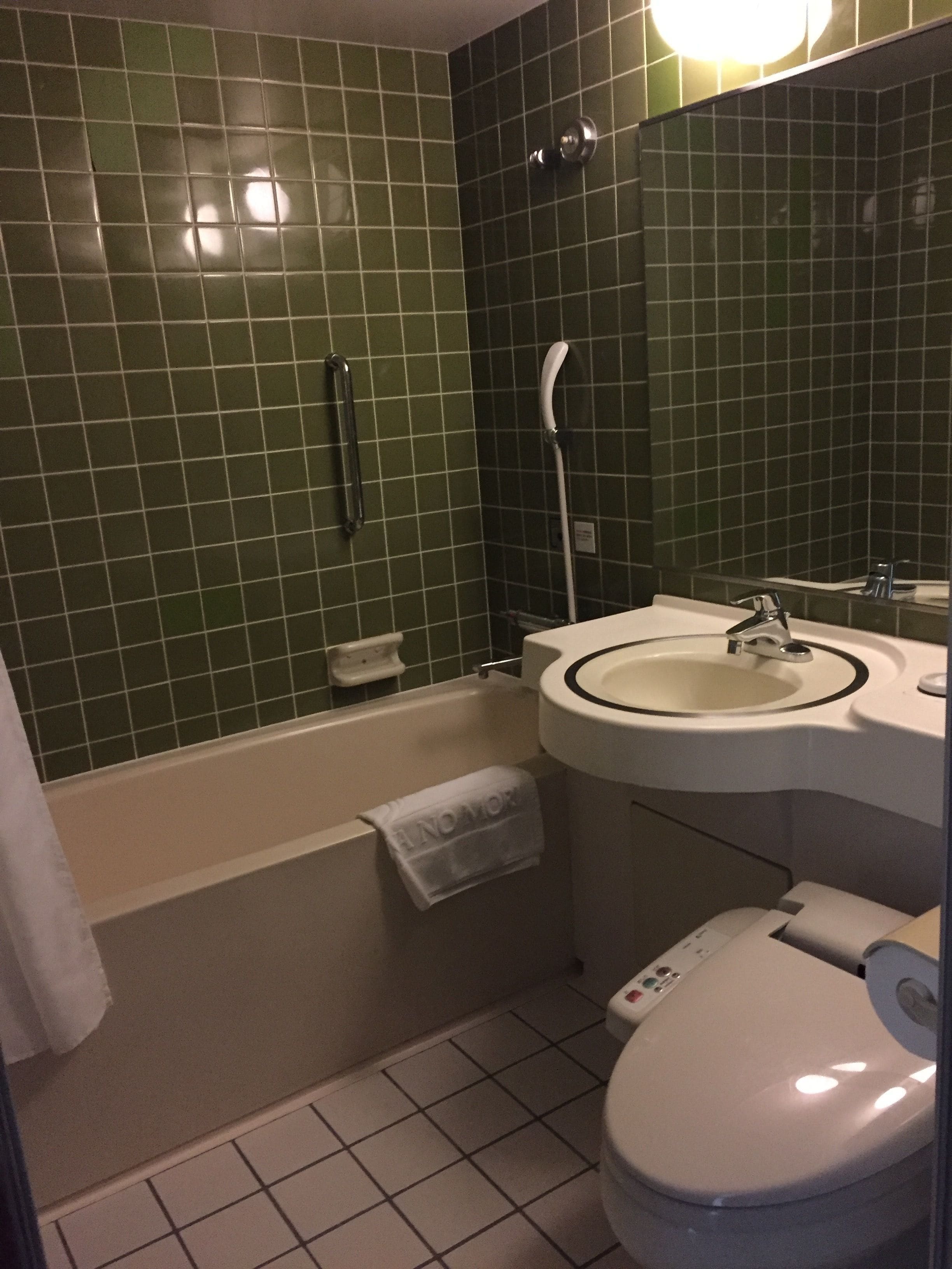 A bathroom with a bathtub, a sink, and a toilet.