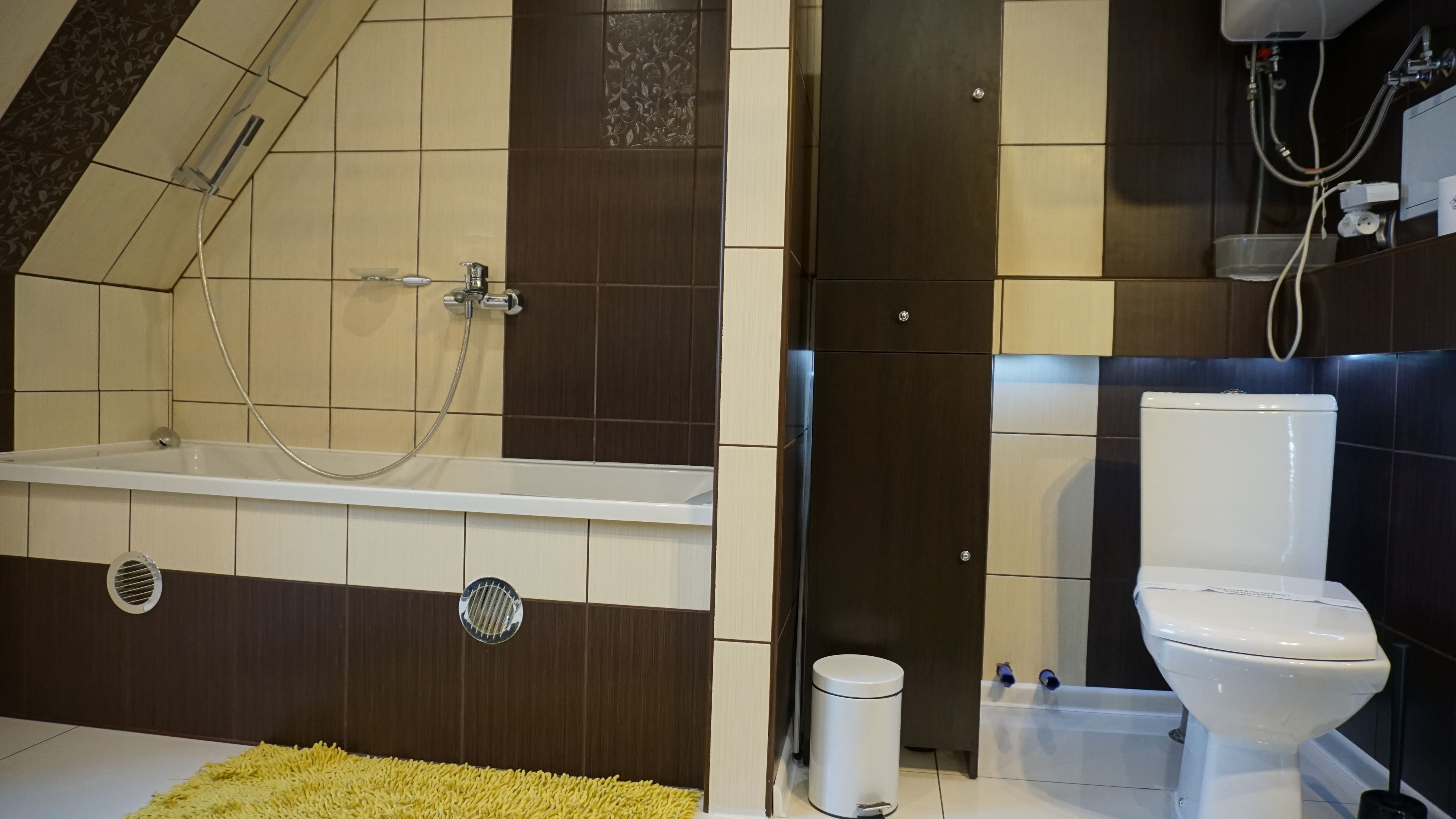 A bathroom with a bathtub, toilet, and shower.