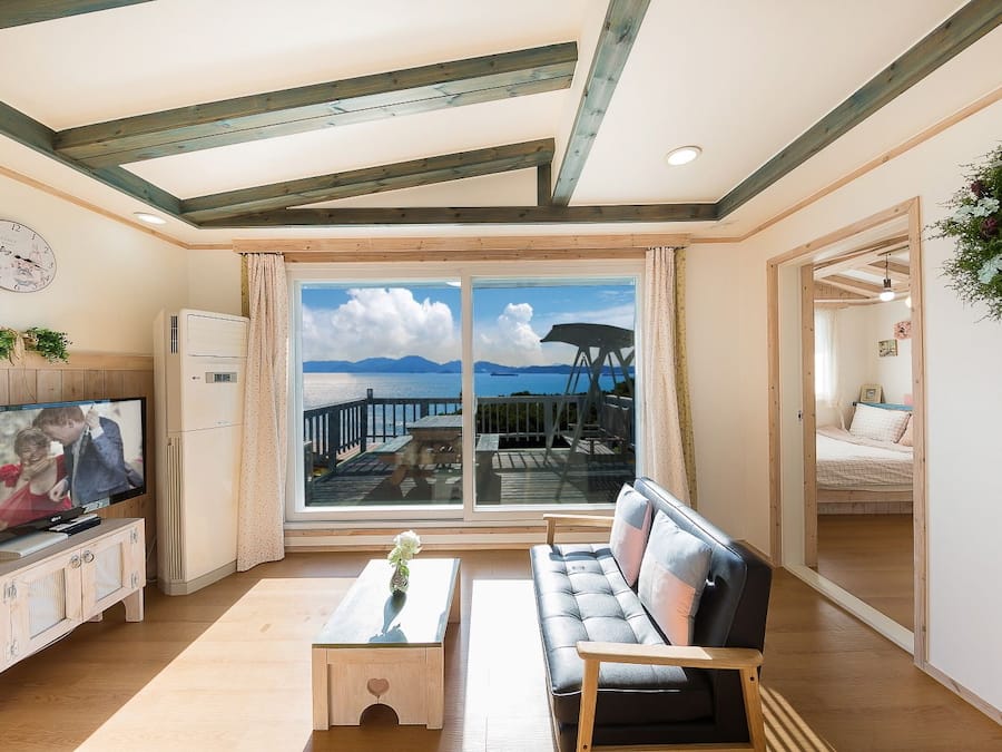 Superior Apartment, 1 Bedroom, Sea View | Living area | Flat-screen TV, heated floors