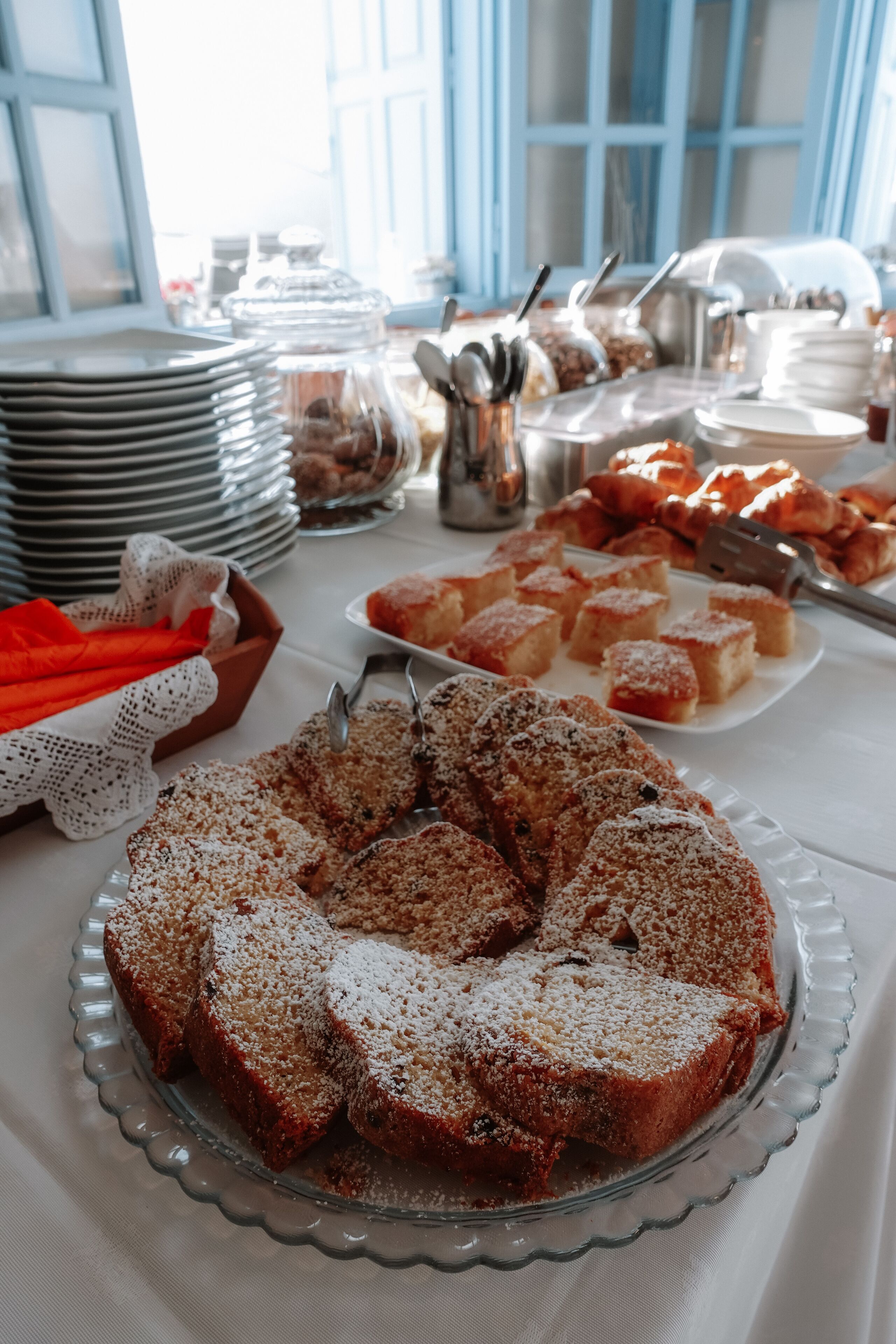 A buffet table with various food items, including a large cake and several dishes.