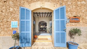 A stone building entrance with blue shutters, a sign indicating 'Superior TI/109', and a 'BC' sign. - Es Corte Vell - Inland Bunyola - Adults Only (Bunyola)