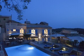 A hotel with a swimming pool, outdoor seating, and a view of the surrounding landscape. - Es Corte Vell - Inland Bunyola - Adults Only (Bunyola)