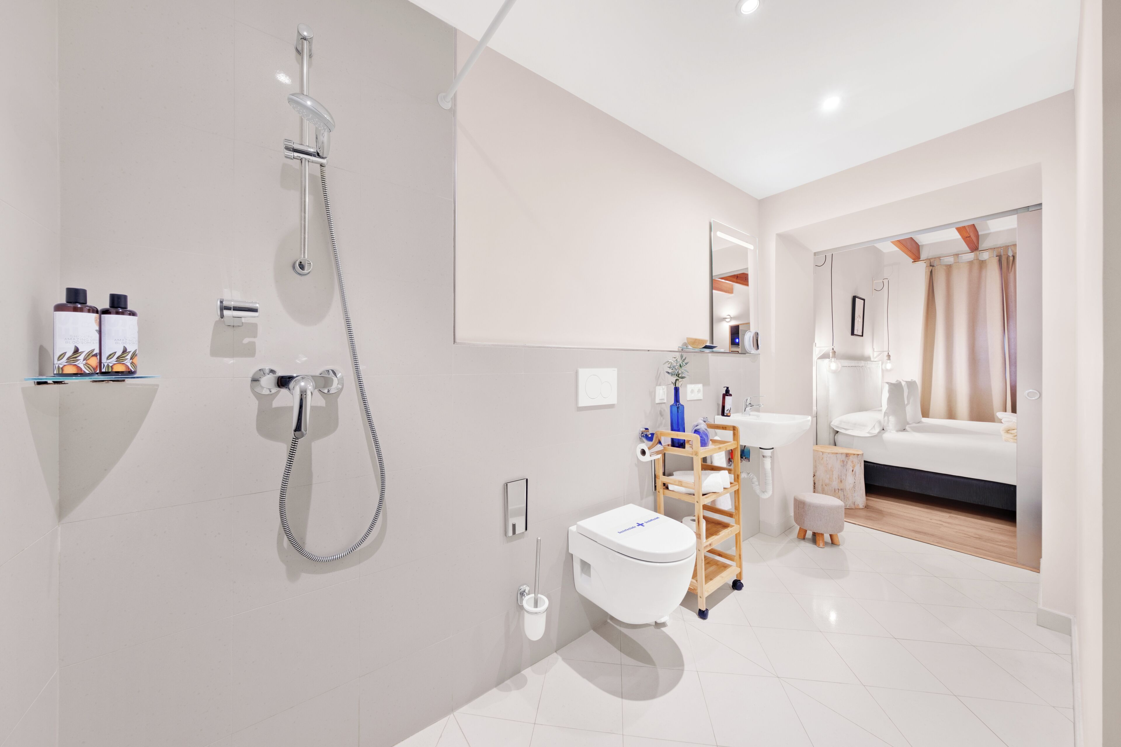 A modern bathroom with a shower, toilet, and sink.