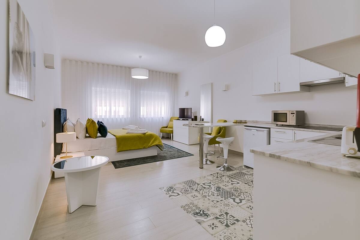 A modern apartment with a living area, kitchen, and dining space.