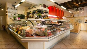 A buffet area with various food items and a wine selection.