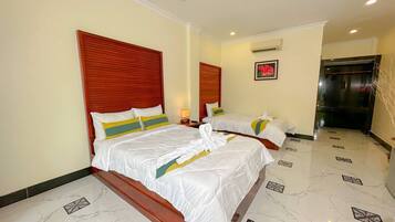 A hotel room with two beds, a marble floor, and a modern design.