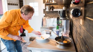 A modern kitchen with stainless steel appliances, a coffee maker, and a variety of kitchen utensils. - Arctic gourmet cabin (Kiruna)
