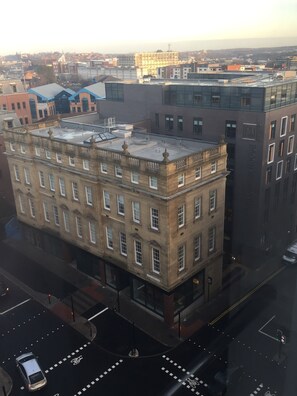 A multi-story building with a classic architectural style, featuring a prominent corner entrance and large windows. - Plummer House (Newcastle-upon-Tyne)