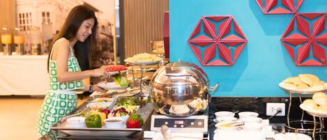 A buffet setup with various food items and a buffet station.