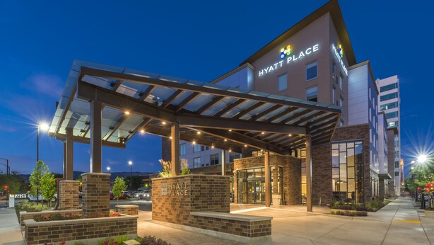 A Hyatt Place hotel entrance with a covered walkway, brick facade, and glass doors. - Hyatt Place Boise/Downtown (Boise)