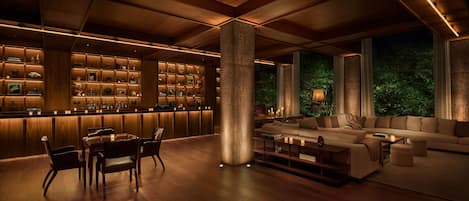 A modern interior with a bar area, seating, and a large pillar.