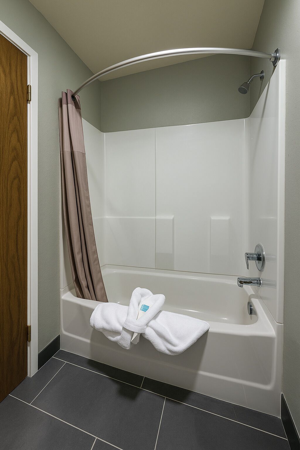 A modern bathroom with a freestanding bathtub, a shower, and a towel rack.