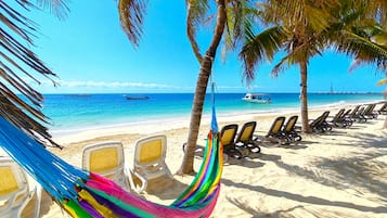 On the beach, sun-loungers