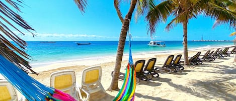 On the beach, sun-loungers