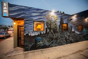 A building with a mural depicting a dystopian scene. - PodShare Los Feliz - Hostel (Los Angeles)