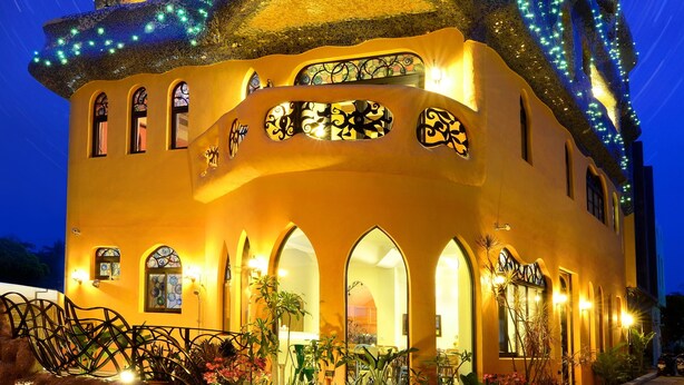 A building with a unique architectural design featuring arched windows and a tiered roof.