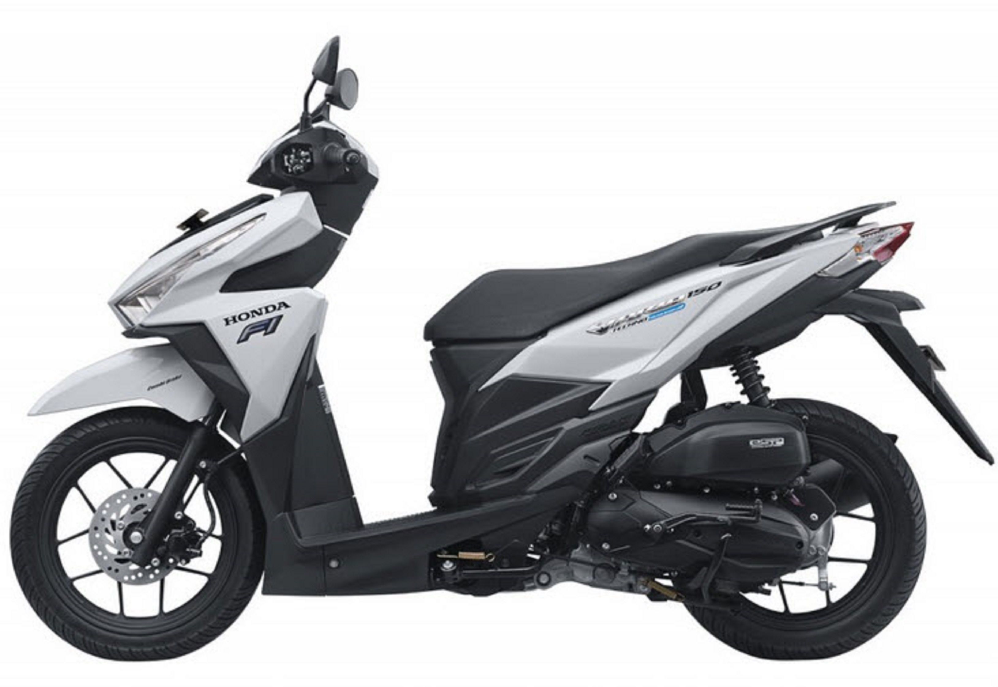 A Honda scooter with a sleek design, a digital display, and a storage compartment.