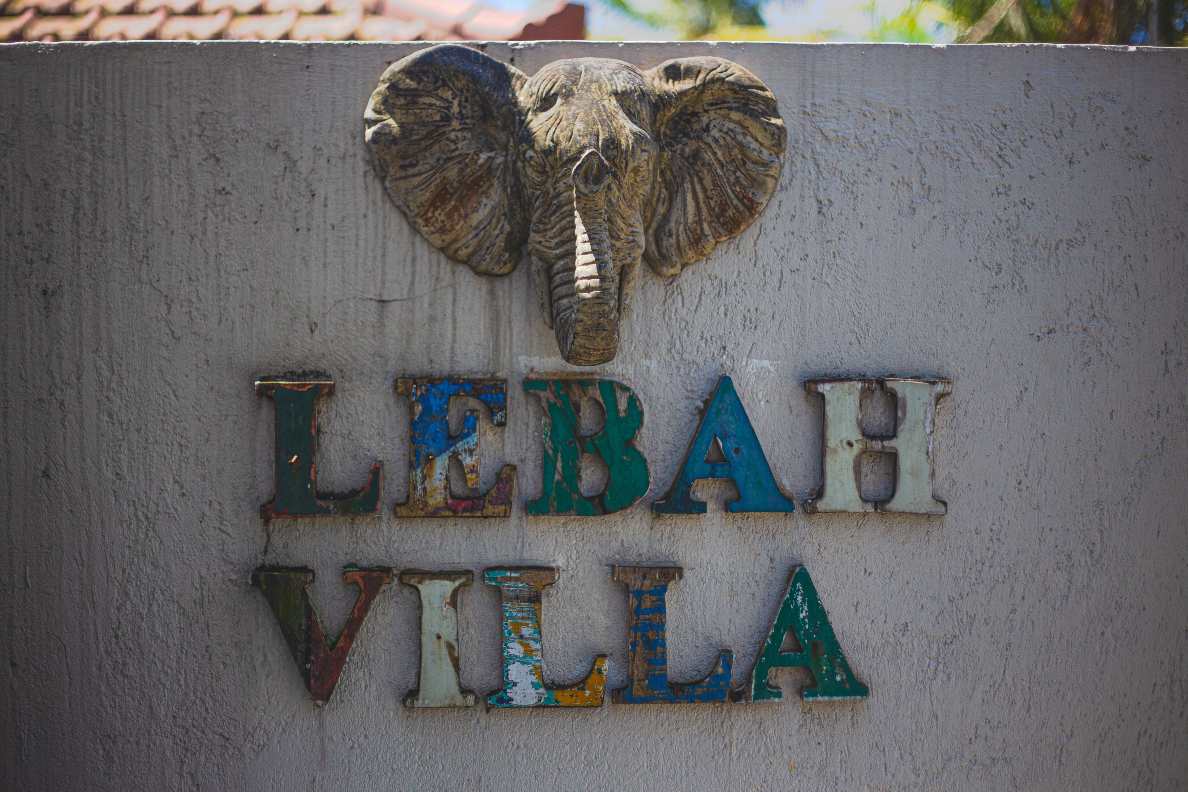 A sign with an elephant head and the text "LEBAR VILLA".