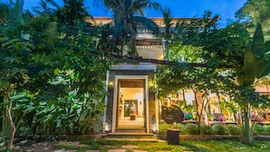 A well-maintained garden with a pathway leading to a building entrance. - GZ Angkor Boutique (Siem Reap)