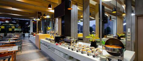 A buffet setup with various food items and a long counter.