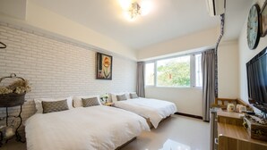 A hotel room with two beds, a large window, a TV, and a brick wall. - Tainan Anping Bailuwan House (Tainan)