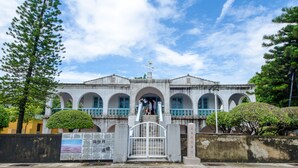 A historic building with a central staircase, arched windows, and a balcony. - Tainan Anping Bailuwan House (Tainan)