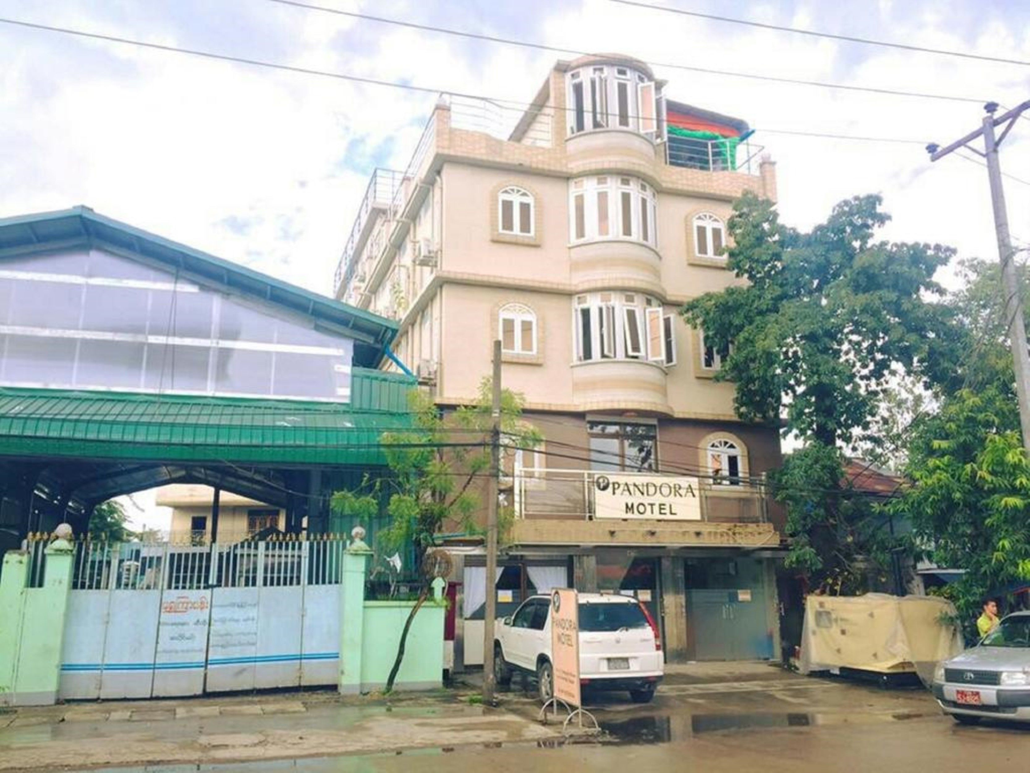 A multi-story building with a sign for 'Pandora Motel'.