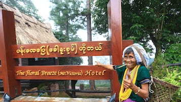 A wooden sign with the name of a hotel.