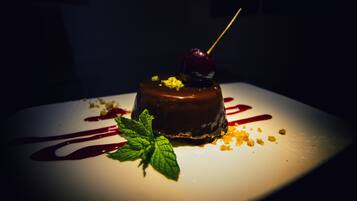A dessert on a white plate with a dark background.