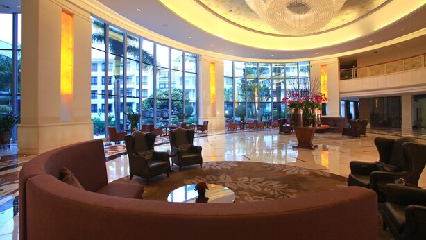 A spacious lobby with a curved seating area, large windows, and a chandelier. - Kylin villa (Shenzhen)