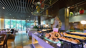 A modern restaurant with a variety of breads and pastries displayed on a counter. - Kylin villa (Shenzhen)
