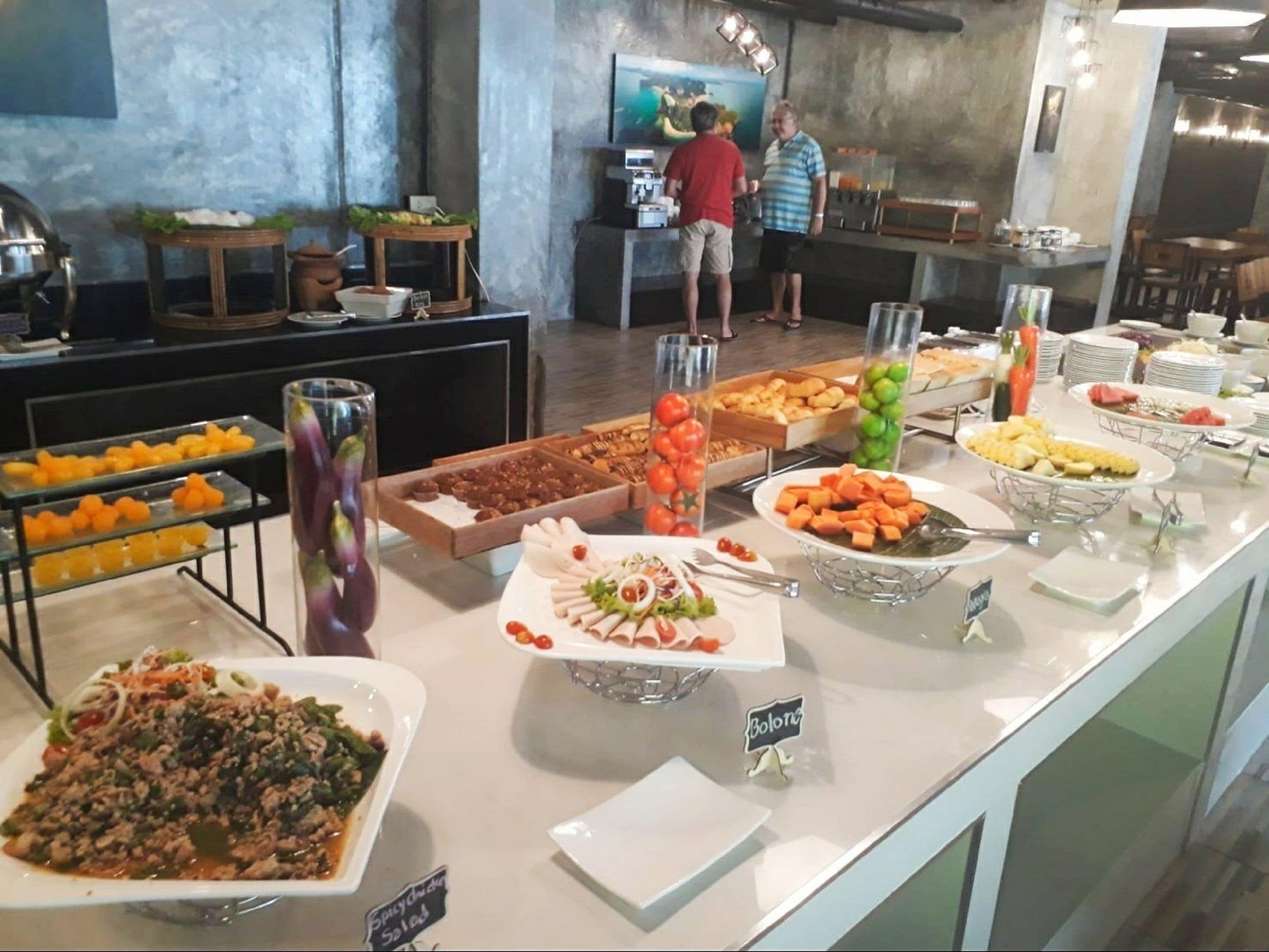 A buffet with various food items and a sign indicating 'Bolone'.