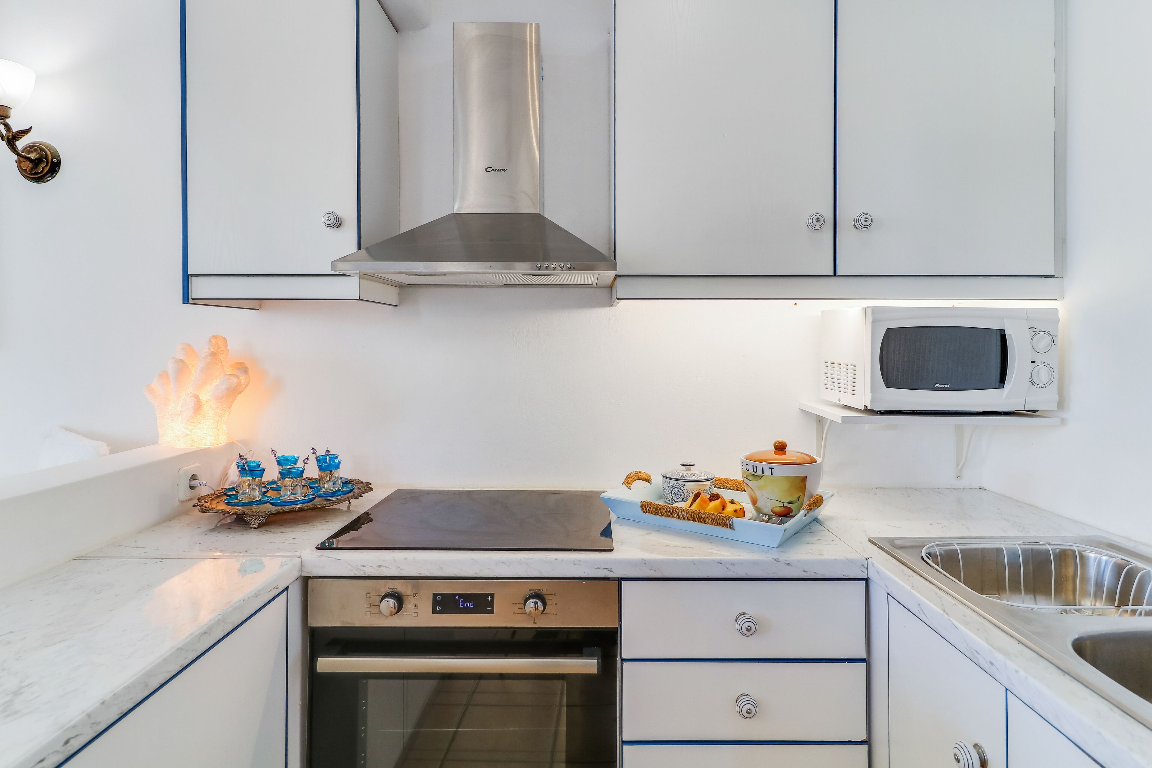 A modern kitchen with stainless steel appliances, a built-in oven, and a microwave.