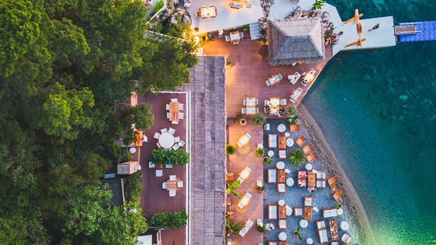 An aerial view of a resort with outdoor seating areas, a pool, and a beach. - Dukley Hotel & Resort (Budva)
