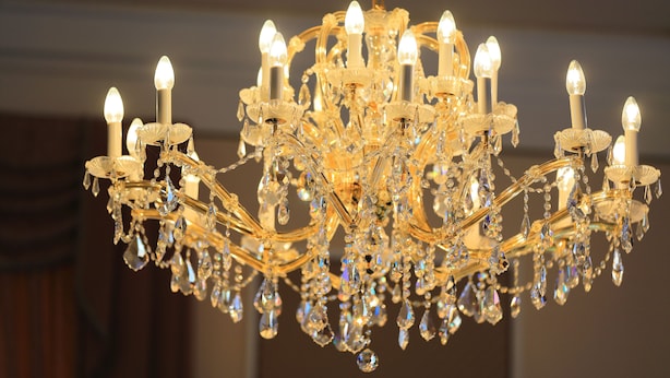 A chandelier with multiple light fixtures and crystal decorations. - Hotel Bellevue Vienna (Vienna)