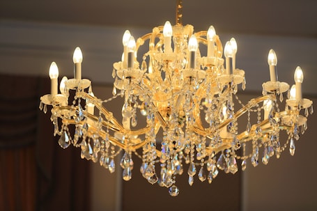 A chandelier with multiple light fixtures and crystal decorations.